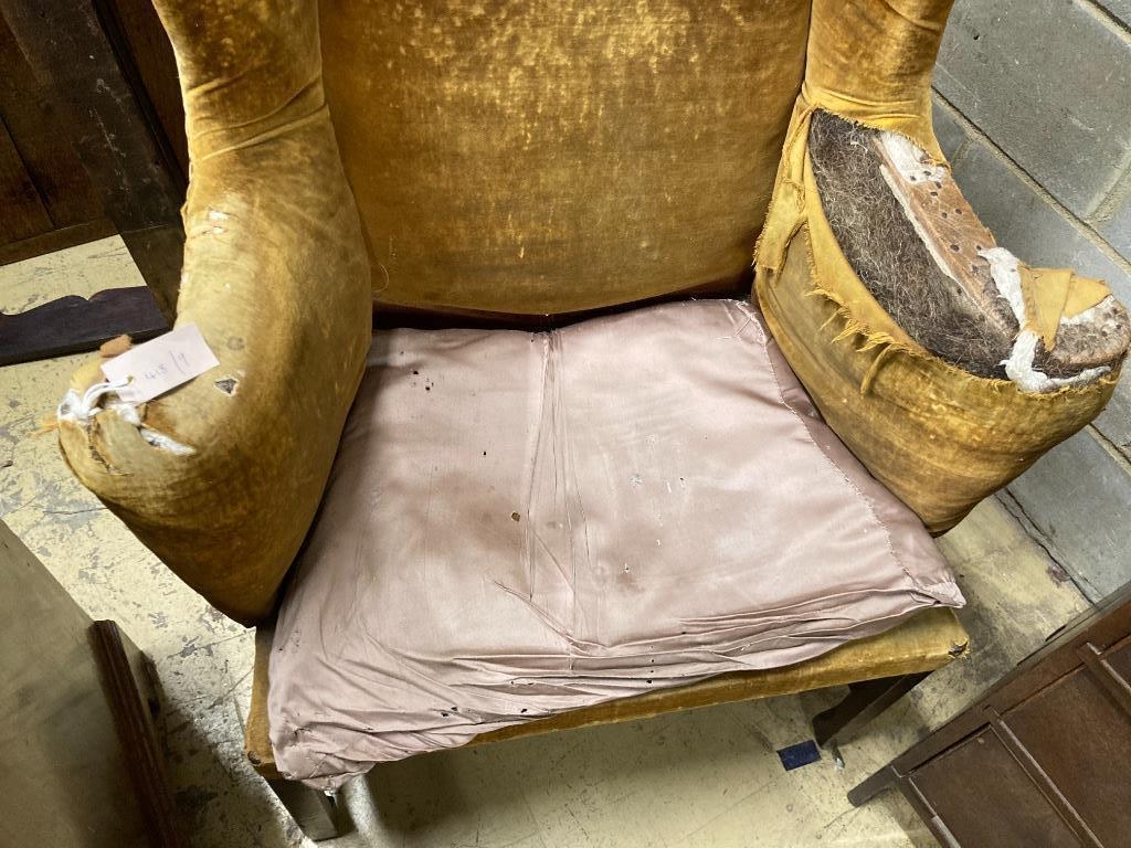 A George III provincial wing armchair, width 83cm, depth 60cm, height 124cm